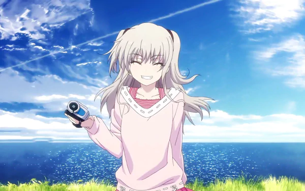Nao Tomori from the anime Charlotte smiles holding a camera against a scenic background of a blue sky and ocean. This HD wallpaper features her white hair fluttering in the breeze.