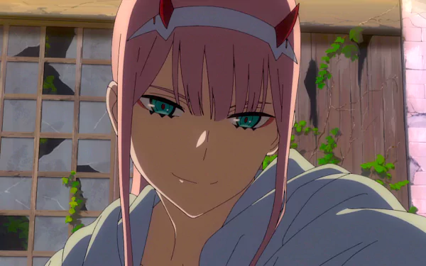 HD desktop wallpaper featuring Zero Two from the anime Darling in the FranXX, showcasing a close-up of her confident smile against a rustic background with greenery.