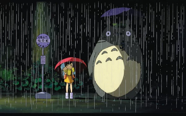 HD wallpaper featuring Totoro, Mei Kusakabe, and Satsuki Kusakabe from My Neighbor Totoro standing in the rain with umbrellas at a bus stop.