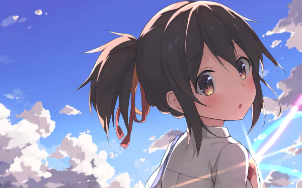 HD wallpaper of Mitsuha Miyamizu from the anime Your Name, featuring her with brown eyes and short brown hair tied in a ponytail. She gazes softly back at the viewer against a vibrant, cloudy sky background.