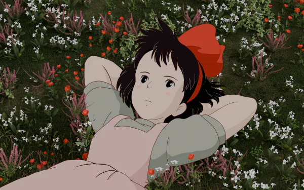 Kiki from Studio Ghibli's anime Kiki's Delivery Service (Majo no Takkyūbin) lies on a flower-filled meadow in this 4K Ultra HD PC wallpaper.