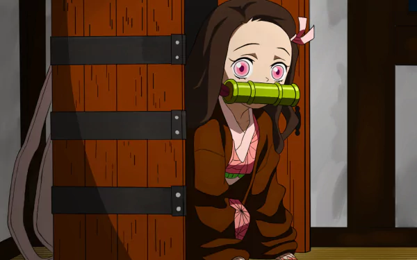 HD desktop wallpaper featuring Nezuko Kamado from the anime Demon Slayer: Kimetsu no Yaiba, showing her peeking out from behind a wooden box with a bamboo muzzle in her mouth.