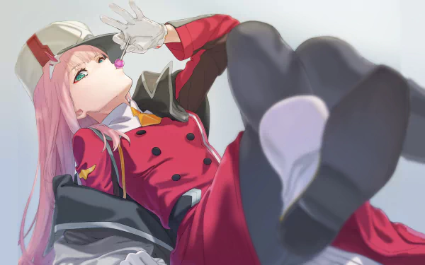An HD wallpaper featuring Zero Two from Darling in the FranXX, with pink hair, green eyes, and a lollipop, dressed in a red uniform with a hat and glove, lying down with a confident expression.