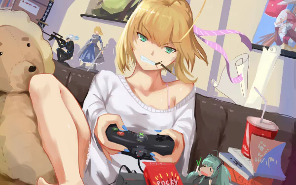 Anime character Saber Lily with blonde short hair playing video games, holding a controller. Background includes various snacks, a large teddy bear, and anime figurines. HD desktop wallpaper from Fate/Stay Night series.
