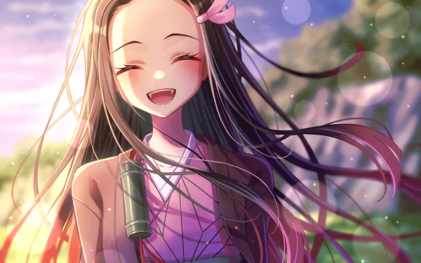HD desktop wallpaper features Nezuko Kamado from the anime Demon Slayer: Kimetsu no Yaiba. She is smiling brightly with long hair flowing in a scenic background.